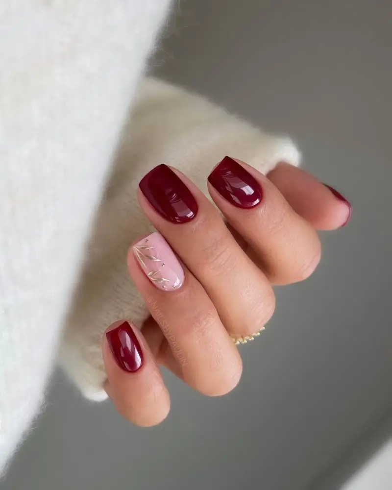 21. Red manicure with gold detail