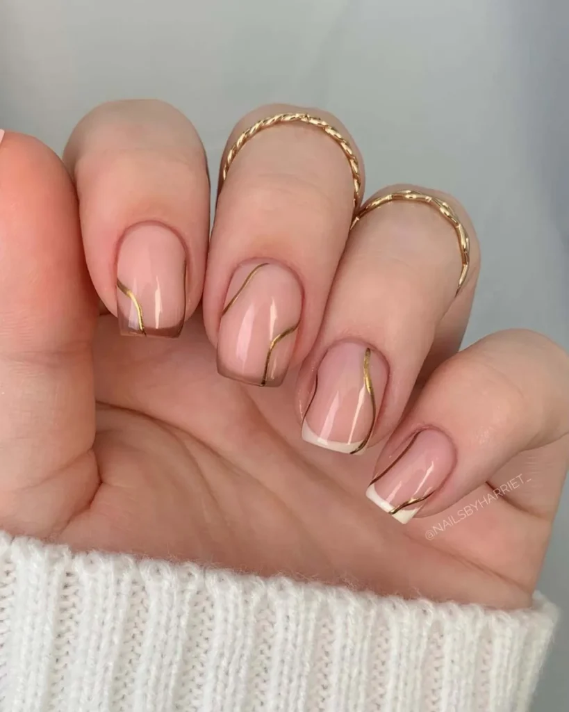 29. Gradient Brown French Manicure With Gold Nail Art