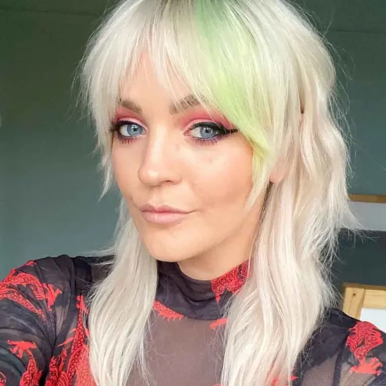Bleached Blonde Soft Mullet With Curtain Bangs and Mint Green Highlights