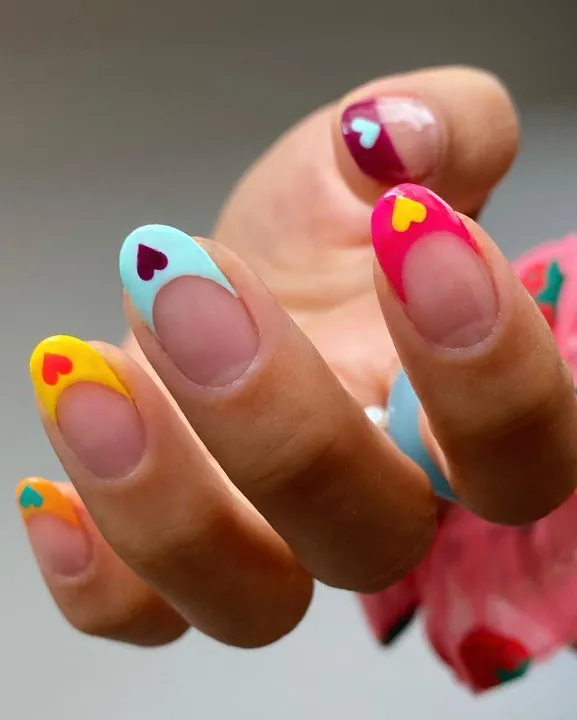 Bright French tip nails with colourful hearts