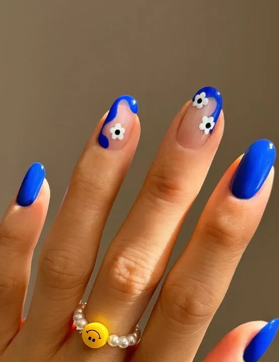 Bright blue nails with dainty flower designs