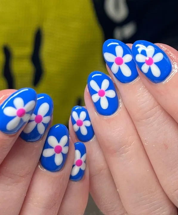 Bright blue spring gel nails with pink and white flowers