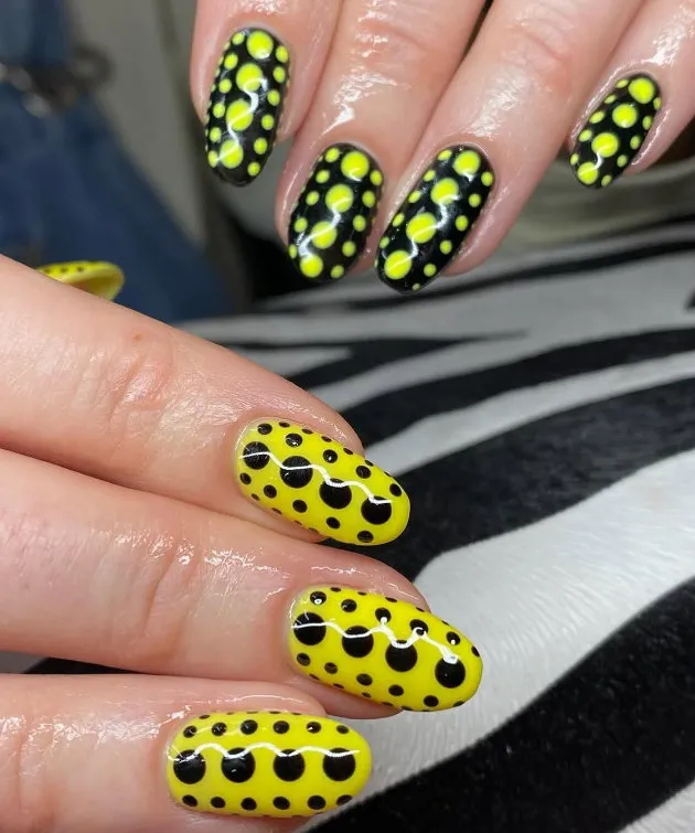 Bright yellow and black long nails with dot work design