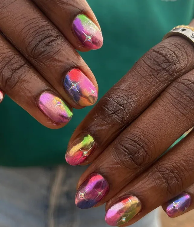 Winter neon chrome nails with stars and gems
